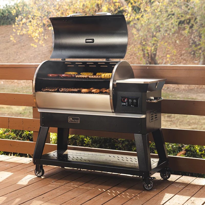 recteq Backyard Beast 1200 pellet grill with the lid open, food cooking on the grates, on an outdoor patio
